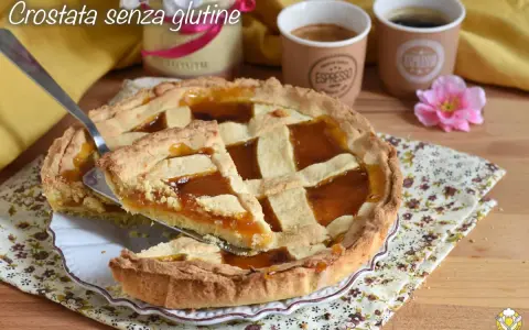 Una deliziosa crostata senza glutine con marmellata d'arancia, pronta per essere gustata con un caffè.