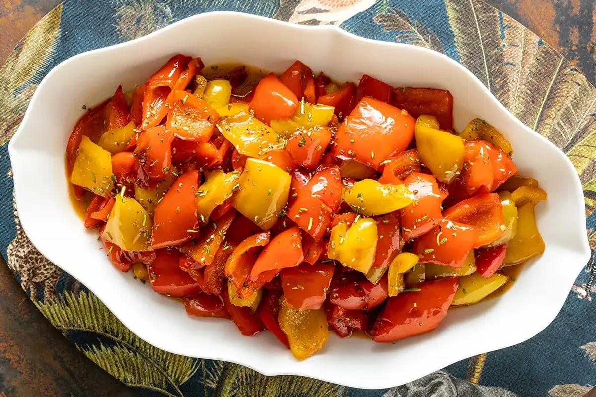 Peperoni in agrodolce, un contorno colorato e saporito, servito in una ciotola bianca.